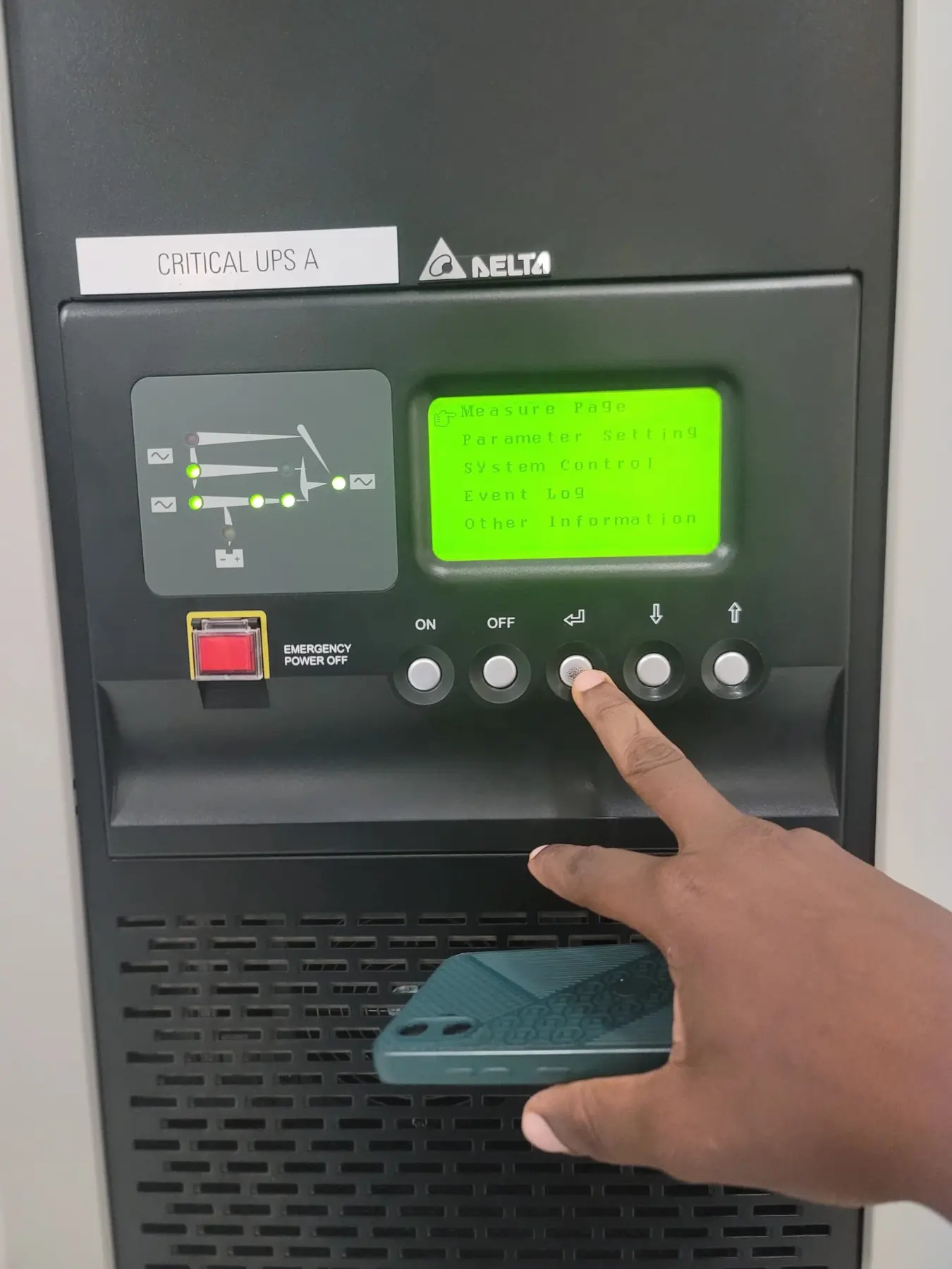 Technician performing an operating check on a critical UPS panel